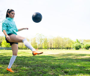 Full length of man playing soccer on field