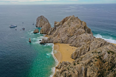 High angle view of rocks on sea shore