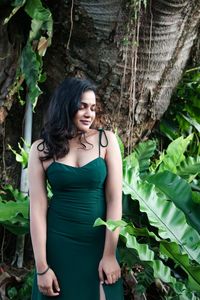 Full length of woman standing against plants