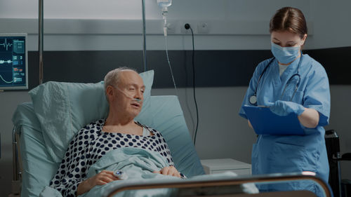 Nurse examining patient at clinic