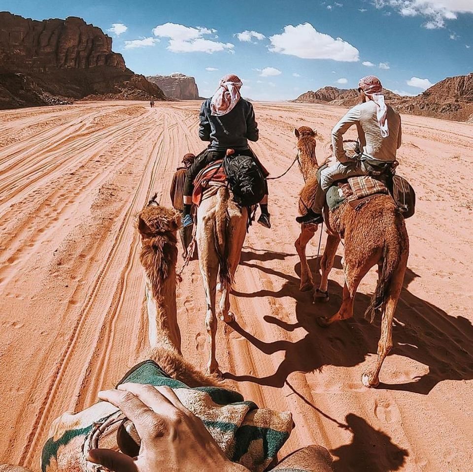 PEOPLE RIDING HORSE IN DESERT