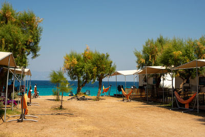 People at beach against clear sky