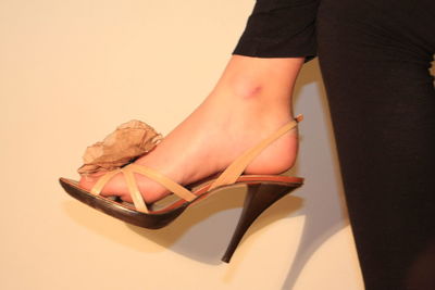 Low section of woman wearing high heels