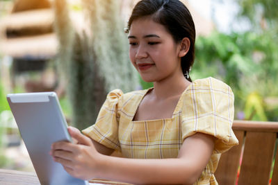 Young woman using mobile phone outdoors