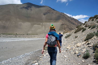 Rear view of man walking on mountain