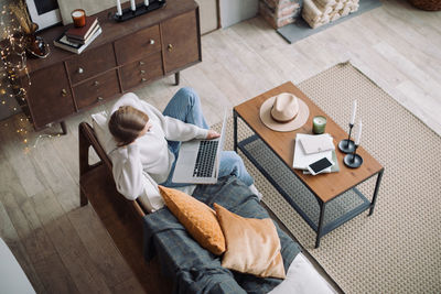 High angle view of man using mobile phone at home