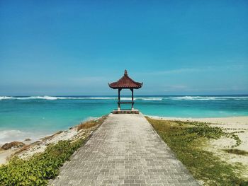 Lifeguard hut on beach against sky