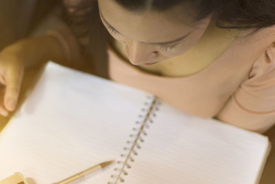 High angle view of woman reading book