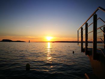 Scenic view of sea against clear sky during sunset