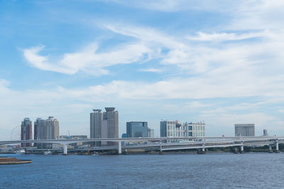 View of city by sea against sky