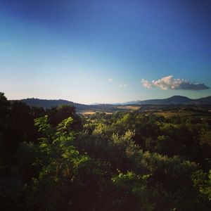Scenic view of mountains against blue sky