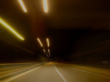 Light trails on road in tunnel at night