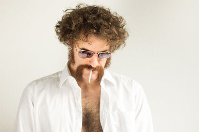 Man smoking cigarette against white background