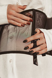 Corset, white shirt and hand with manicure