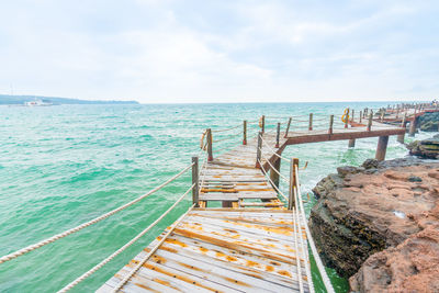 Pier over sea against sky