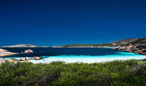 Scenic view of sea against clear blue sky