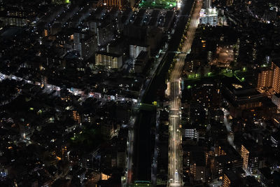 High angle view of modern buildings in city at night