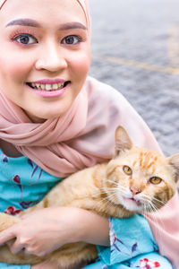 Portrait of smiling woman with cat