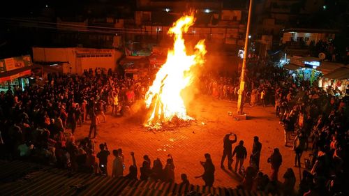 People celebrating holi festival at night