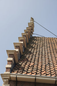 Low angle view of roof and building against clear sky