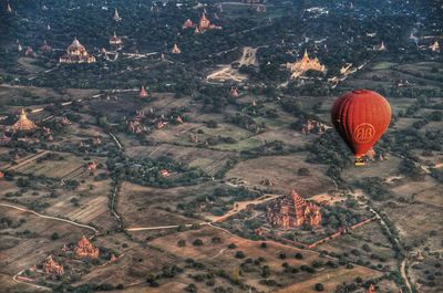 High angle view of hot air balloons on field