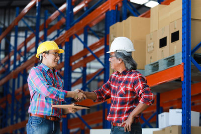 Low angle view of people working at building