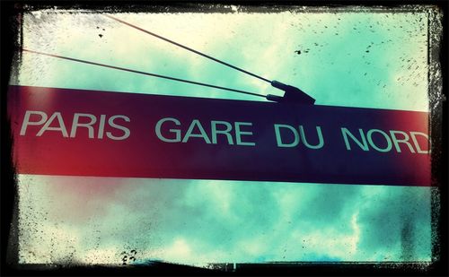 Low angle view of information sign against sky