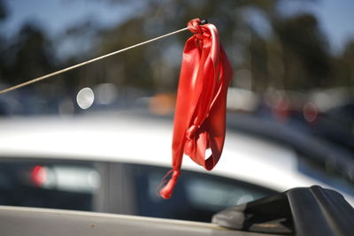 Close-up of red bell hanging on car