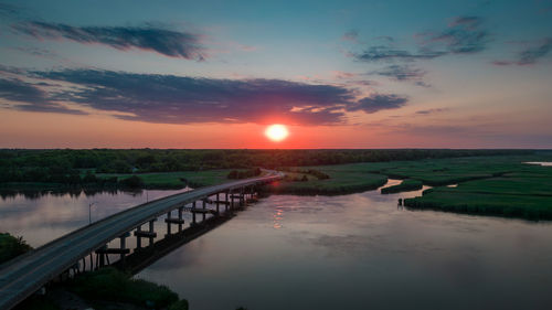 Aerial shot of the sun setting over the maurice river bridge in south new jersey