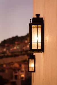 Outdoor rustic wall light. city lights in the background.