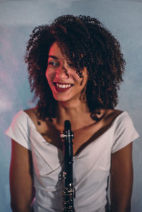 Portrait of smiling young woman holding hair