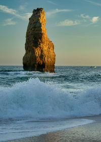 Rock formation on sea against sky