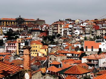 High angle view of houses in town against sky