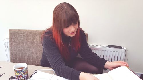 Young woman sitting at home