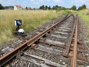 High angle view of railroad tracks on field against sky