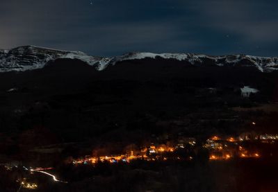 Illuminated mountains against sky at night