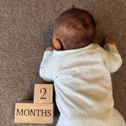 High angle view of baby boy with toy on floor at home