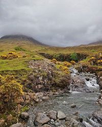 Scenic view of landscape against cloudy sky