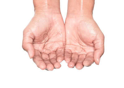 Close-up of human hand over white background