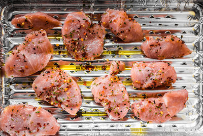 High angle view of raw meat on aluminum foil