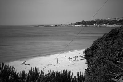 Idyllic view of beach against clear sky