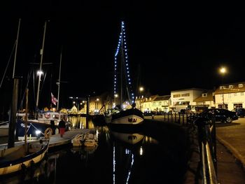 Boats in harbor at night