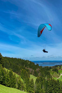 Person paragliding against sky