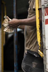 Midsection of person standing outdoors