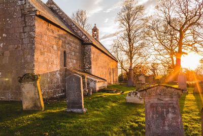 View of cemetery and building against sky