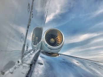 Cropped image of airplane flying against sky