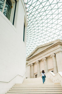 Low angle view of woman standing against building