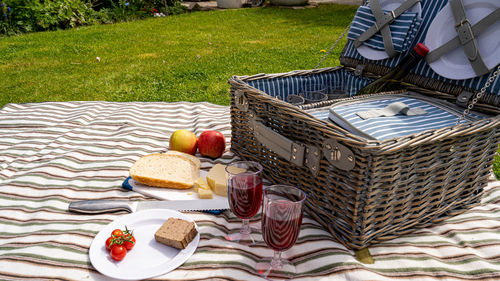 Summers day picnic set on the lawn with food and sparkling wine