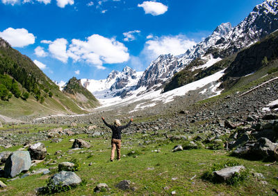 Rear view of man walking on mountain