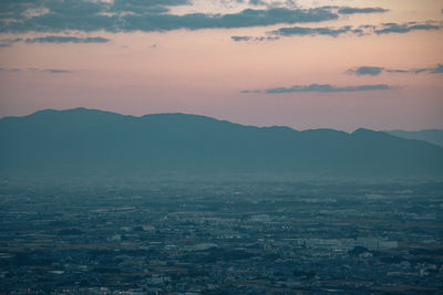 Aerial view of townscape against sky during sunset